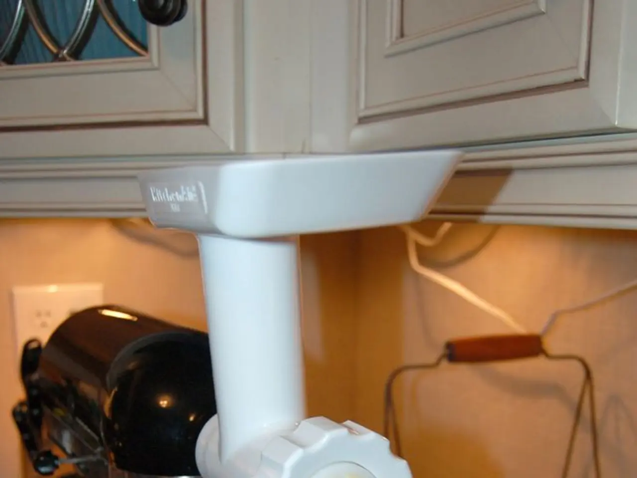 In this image, I can see a cake beating machine, a bowl, a basket of fruits and few other objects...