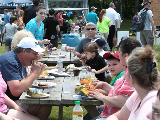 In this picture i could see number of many number of persons sitting around the table and having a...