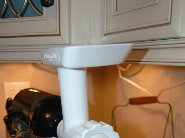 In this image, I can see a cake beating machine, a bowl, a basket of fruits and few other objects...