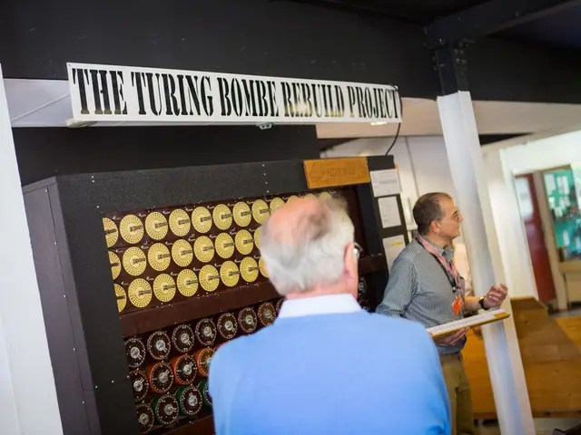 In the picture we can see a man standing near some machine and on the top of it, we can see the...