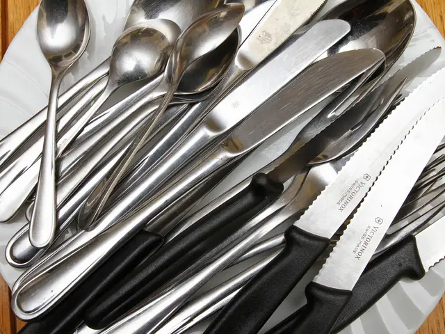 Here we can see spoons,forks,knives on a plate on a platform.